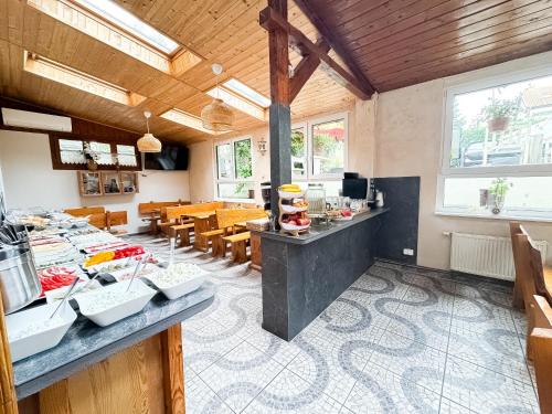 a kitchen and dining room with tables and chairs at VILLA SUNNY ROSE Bed & Breakfast in Świnoujście