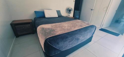 a small bed in a small room with at DAINTREE RAINFOREST Private ROOM w-Ensuite In my 2 bdroom home in Cow Bay