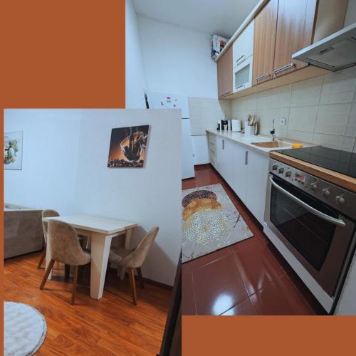 a kitchen with a table and a stove top oven at Explore and Relax 1BR apartment in Ferizaj