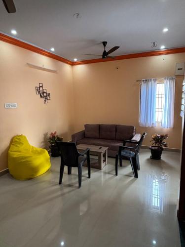 a living room with a couch and chairs at Entire 2BHK and a garden parking in Tiruvannāmalai