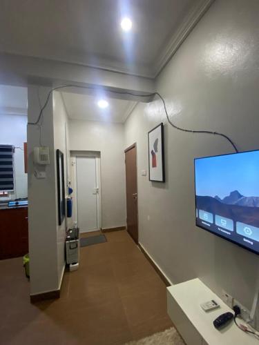 a hospital room with a flat screen tv on the wall at Studio Apartment Wuye-City Center in Abuja