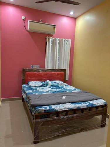 a bedroom with a bed in a room with a air conditioner at Entire 2BHK and a garden parking in Tiruvannāmalai