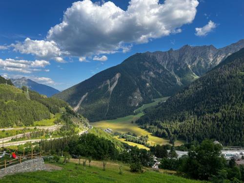 a view of a valley in the mountains at La maison du faux monneyeur in Saint-Rhémy-en-bosses