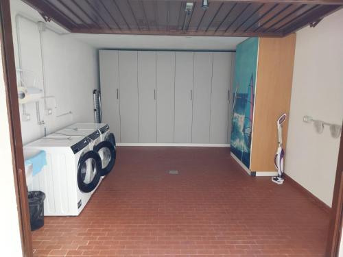 a garage with a washer and dryer in it at The View 1 in Teglio