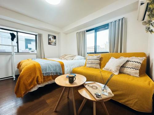 a bedroom with two beds and a couch at sakura 401 in Tokyo