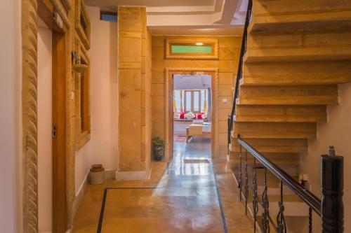 a hallway in a house with wooden stairs at Golden Vista Guest House in Jaisalmer