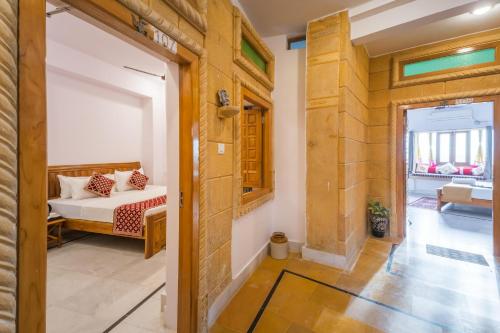 a bedroom with a bed in a room with a window at Golden Vista Guest House in Jaisalmer