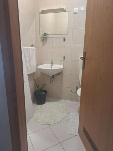 a bathroom with a sink and a toilet at Seaview apartman Vice in Trogir