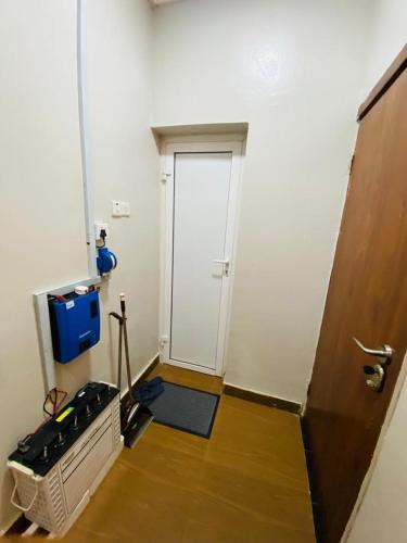 an empty room with a door and a room with a floor at Studio Apartment Wuye-City Center in Abuja