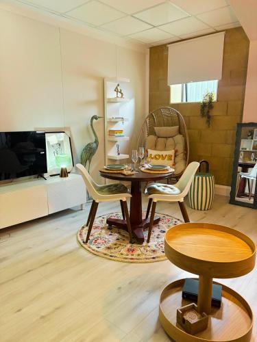 a living room with a table and chairs at Stylish Double Room Park Royal with off-site Gym Access to Showers in London