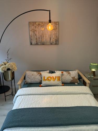 a bedroom with a bed with a love pillow on it at Stylish Double Room Park Royal with off-site Gym Access to Showers in London