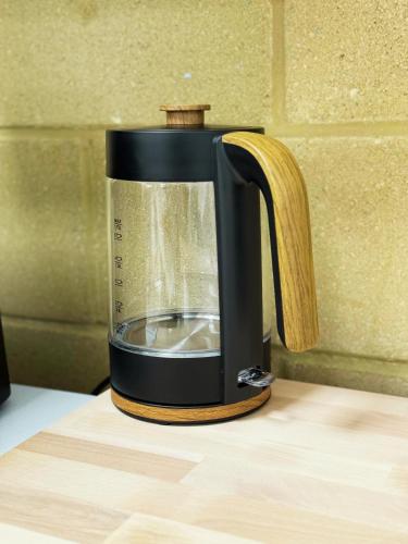 a black coffee maker sitting on a table at Stylish Double Room Park Royal with off-site Gym Access to Showers in London