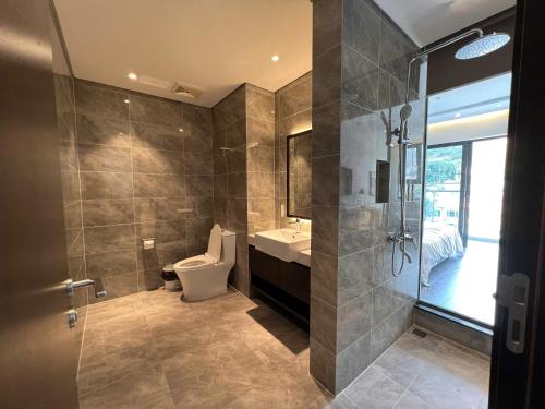 a bathroom with a toilet and a sink and a shower at Homestay Sapphire Hạ Long in Ha Long