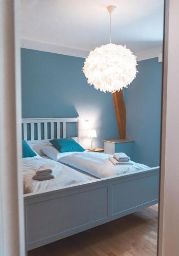 a bedroom with a large bed with a large light at Ferienwohnung Maierers Schaiere in Gammesfeld