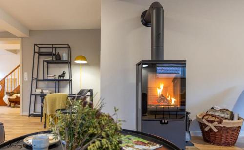 a living room with a fire in a stove at Ferienhaus Honey Bee in Billingsbach