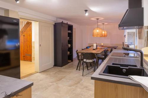 a kitchen and dining room with a table and a sink at Ferienhaus Honey Bee in Billingsbach