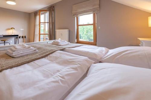 a large white bed with towels on top of it at Landvilla Diebach in Diebach