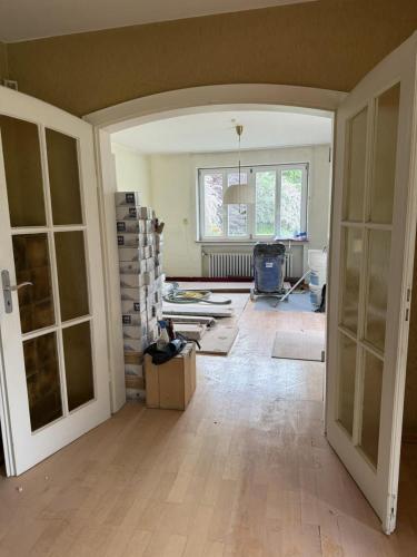 an empty room with a room with boxes and doors at Villa von EmMa in Rot am See