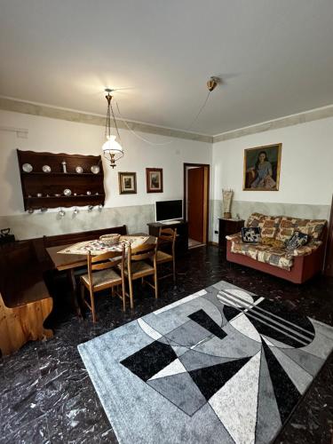 a living room with a table and a couch at Residenza Dei Parchi in Sondrio