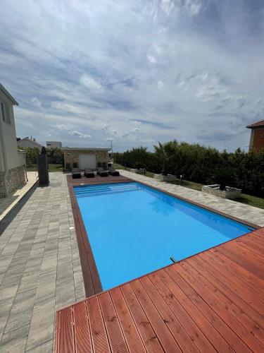 a large blue swimming pool on a patio at Villa Smokva in Smoković