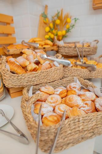 a group of baskets filled with different types of bread at Hotel La Milagrosa in Alicante