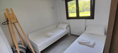a small room with a white couch and a window at Theros-Cottage in Siviri