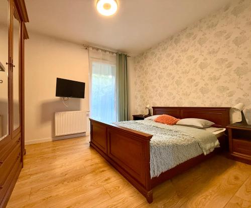 a bedroom with a bed and a television in it at Cozy Stay Apartment Szaserów in Warsaw