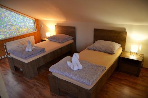 a bedroom with two beds with towels on them at Apartman Aya in Janov nad Nisou