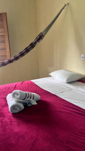 a pair of white towels are sitting on a bed at Recanto flor do maracujá in Ubajara