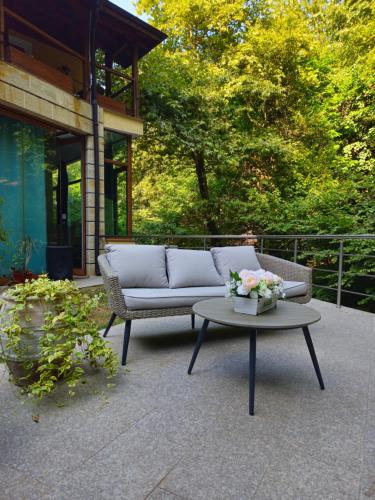 a couch and a coffee table on a patio at Hotel Saint Nedelya in Kolarovo