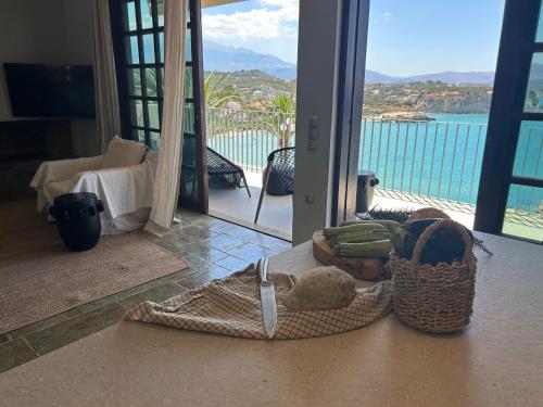 a room with a basket of food and a view of the water at Apartment Sunkiss in Almirida
