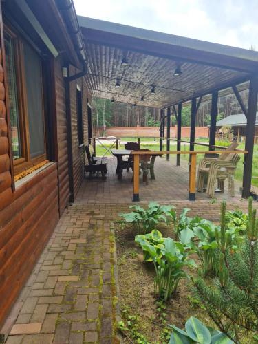 a patio with a table and a picnic table at Leśna Polana- Kompleks Domków Mieszkalnych in Kamionka