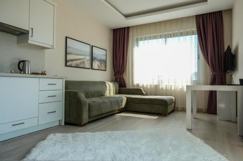 a living room with a couch and a table at Graf Victor Apart Hotel in Alanya