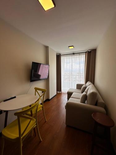 a living room with a couch and a table at Exclusivo Departamento! in Cochabamba