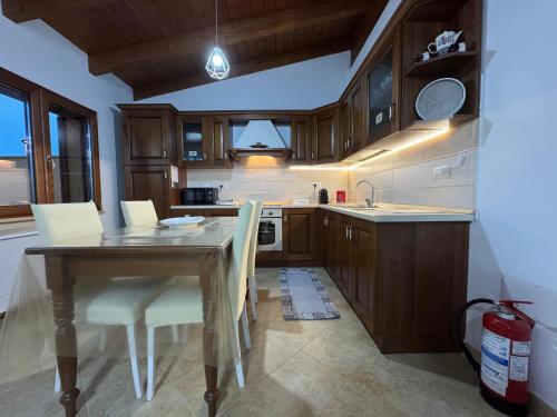 a kitchen with a wooden table and white chairs at Costa gentile in Càbras