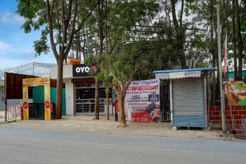 a group of shops on the side of a street at SPOT ON Mango Leaf Restaurant in Bayappanhalli