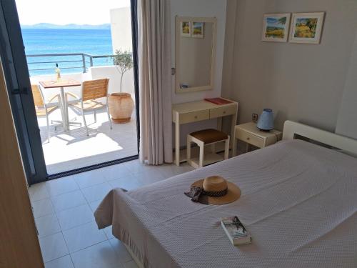 a bedroom with a bed and a view of the ocean at Portobelis Apartments in Sitia