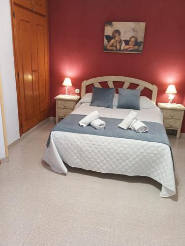 a bedroom with a large bed with two night stands at Alojamientos Castillo de la Iruela in La Iruela