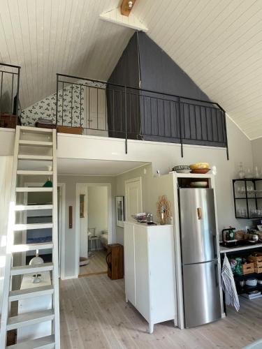 a room with a loft bed and a refrigerator at Idyllically nice house on Bjärehalvön, Torekov! in Båstad