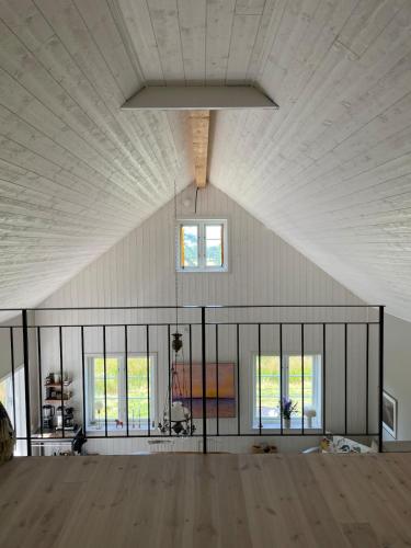 a large room with a white ceiling and windows at Idyllically nice house on Bjärehalvön, Torekov! in Båstad