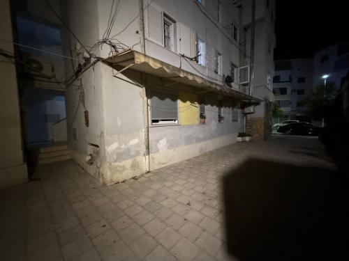 a building with a balcony on the side of it at Lenci's Apartment in Berat