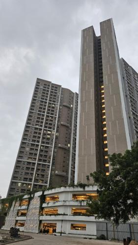 two tall buildings with windows in front of them at SKYLîNE SUITE-2298 in Gandhinagar