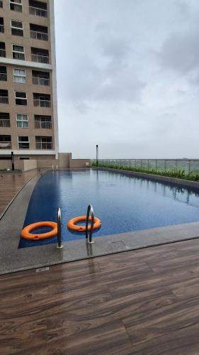 a swimming pool with two orange tubes in it at SKYLîNE SUITE-2298 in Gandhinagar