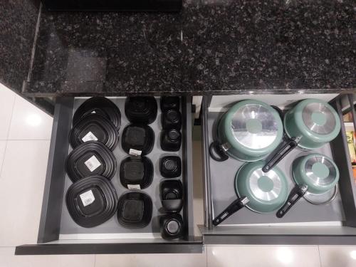 a bunch of pots and pans in a drawer at SKYLîNE SUITE-2298 in Gandhinagar