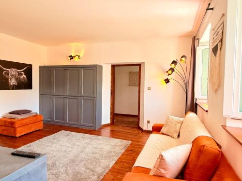 a living room with a couch and a gray cabinet at Castellino di Castello di fiemme in Castello di Fiemme