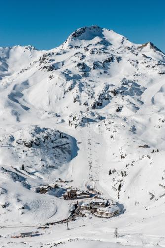 a snow covered mountain with a ski resort on it at Hotel Zehnerkar & Hotel Obertauern in Obertauern