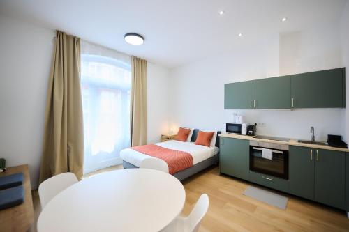 a hotel room with a bed and a table and chairs at Apartment Forest Center 2 in Brussels