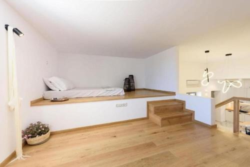 a bedroom with a bed on a wall with a staircase at Fos Residence Dryos in Drios