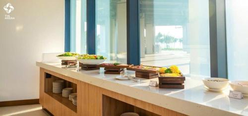 a buffet with bowls of fruit on a counter at Modern Beach Apartment - Arena Resort Cam Ranh in Cam Ranh International Airport