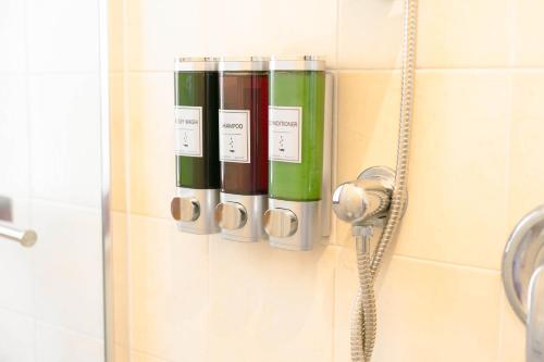 a shower stall with a group of bottles on the wall at Levante Eight Appartamento Vista Mare in Bari